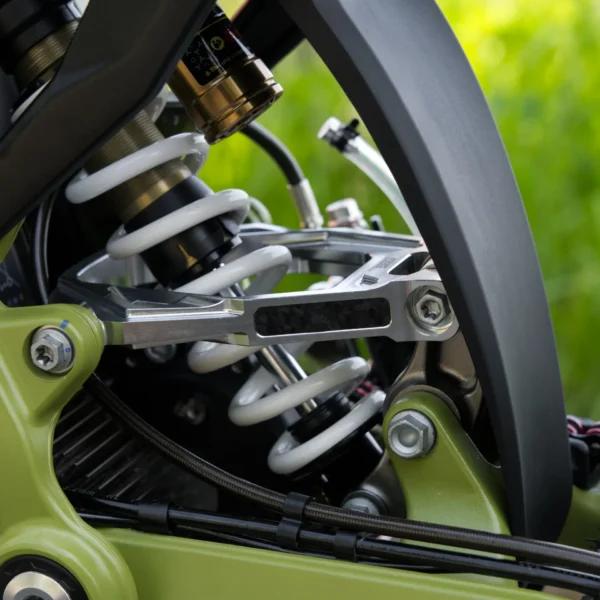 Surron Light Bee 2 billet suspension triangle installed on the rear shock linkage